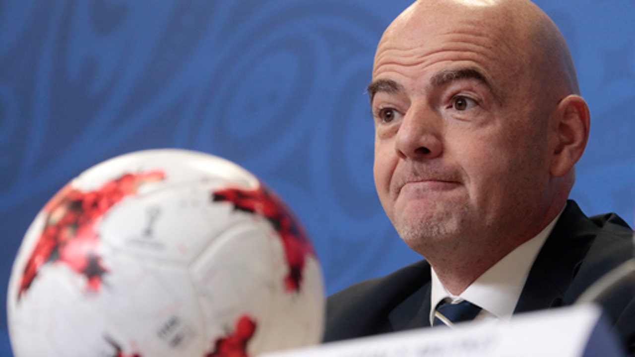 Russia praised for football hosting as doping casts shadow